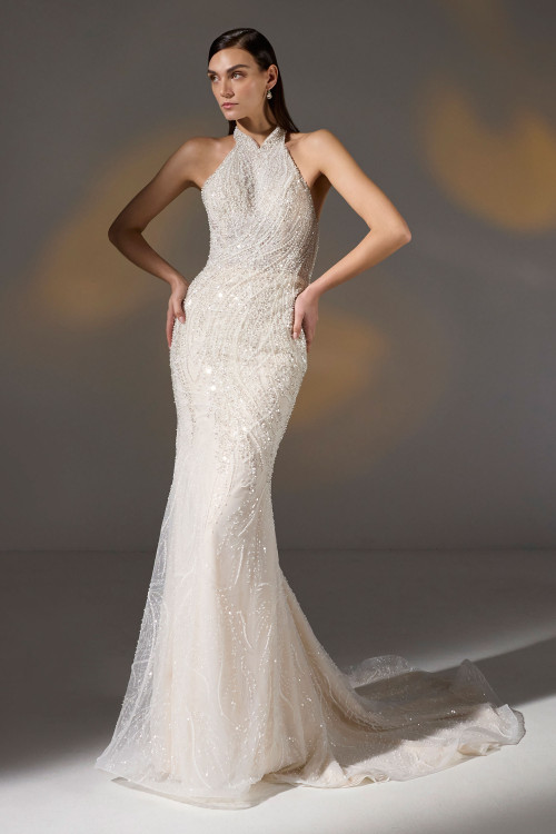 Halter-neck beaded gown dazzles with cascading sequins and a sleek sweep train Halter-neck beaded gown dazzles with cascading sequins and a sleek sweep train
