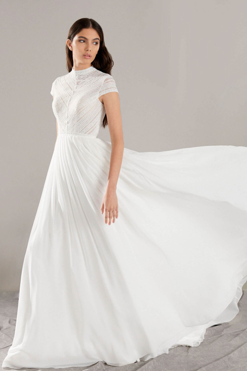 Ethereal chiffon gown with a high neckline, cap sleeves, and soft pleats that float effortlessly Ethereal chiffon gown with a high neckline, cap sleeves, and soft pleats that float effortlessly