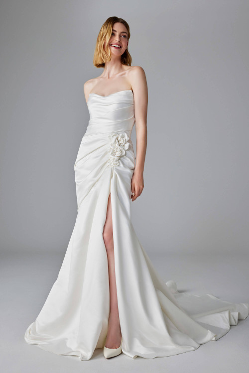 Strapless satin gown with ruched bodice, floral side detail, and a thigh-high slit Strapless satin gown with ruched bodice, floral side detail, and a thigh-high slit