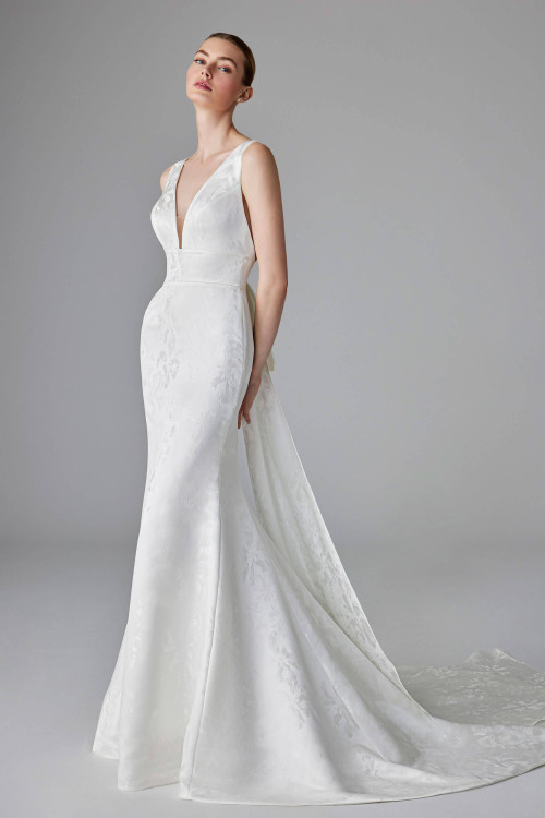 Sleek jacquard gown with plunging neckline, contouring seams, and a modern detachable overskirt Sleek jacquard gown with plunging neckline, contouring seams, and a modern detachable overskirt