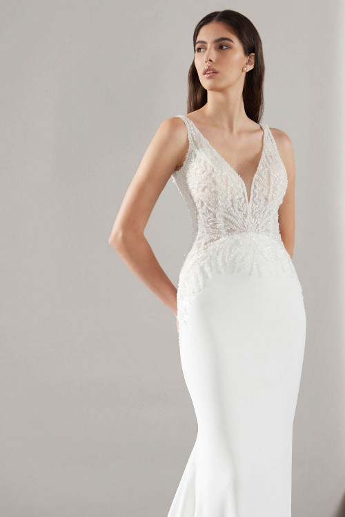 Illusion deep V-neck bodice with intricate beading and a sleek crepe skirt for modern elegance Illusion deep V-neck bodice with intricate beading and a sleek crepe skirt for modern elegance