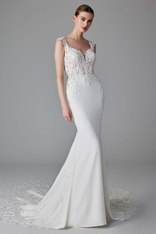 Sheer lace bodice and straps blend into a sleek skirt with a floral lace chapel train Sheer lace bodice and straps blend into a sleek skirt with a floral lace chapel train