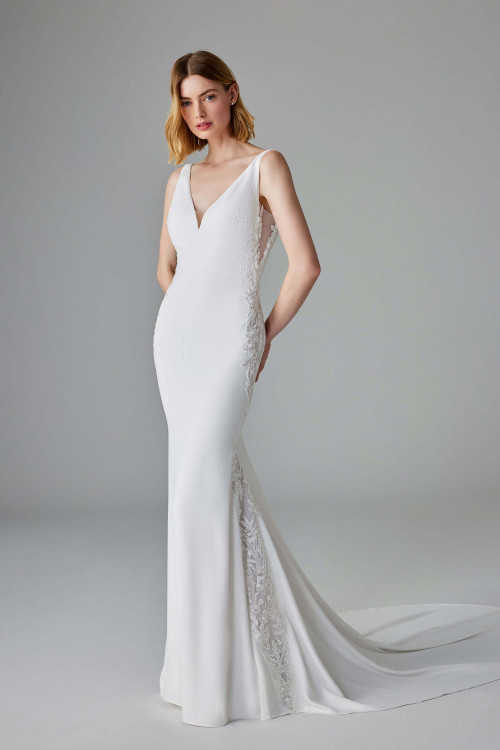 Sleek fit-and-flare gown with plunging V-neckline and illusion lace side panels Sleek fit-and-flare gown with plunging V-neckline and illusion lace side panels