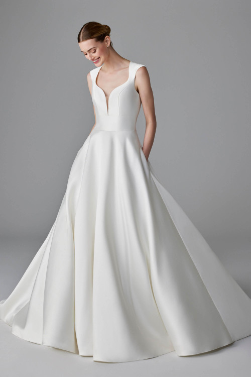 Plunging neckline and structured mikado skirt bring modern drama to this sleek gown Plunging neckline and structured mikado skirt bring modern drama to this sleek gown