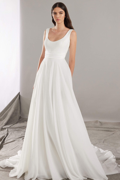 Soft chiffon A-line skirt flows from a scoop neckline bodice with ruched waistband for timeless elegance Soft chiffon A-line skirt flows from a scoop neckline bodice with ruched waistband for timeless elegance