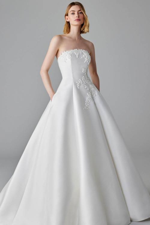 Strapless Mikado gown with floral appliqué bodice and a full skirt with pockets Strapless Mikado gown with floral appliqué bodice and a full skirt with pockets