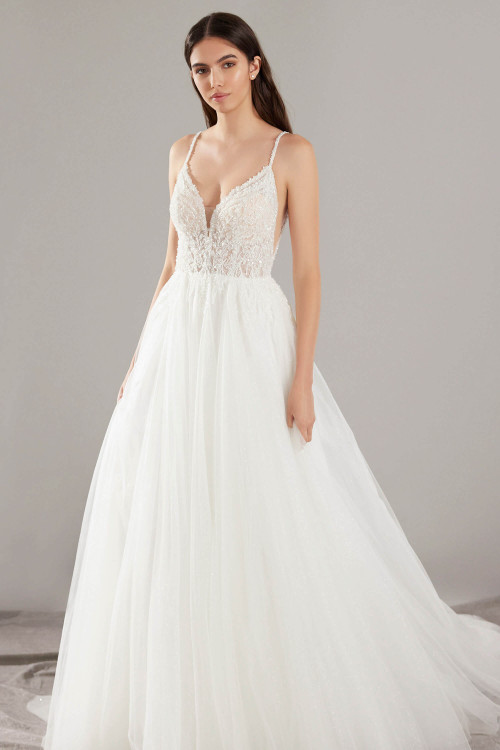This romantic gown features a plunging illusion bodice, delicate beaded straps, and a soft tulle skirt This romantic gown features a plunging illusion bodice, delicate beaded straps, and a soft tulle skirt