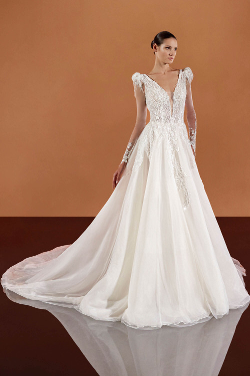 Romantic ball gown with illusion plunge neckline, sculpted shoulders, and beaded embroidery on flowing tulle Romantic ball gown with illusion plunge neckline, sculpted shoulders, and beaded embroidery on flowing tulle