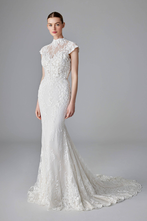 Elegant lace gown with cap sleeves, detachable lace bolero, and a soft chapel-length train