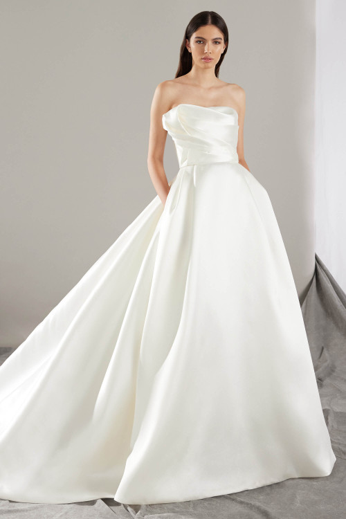 A modern ballgown with architectural draping and hidden pockets for a chic, effortless finish A modern ballgown with architectural draping and hidden pockets for a chic, effortless finish