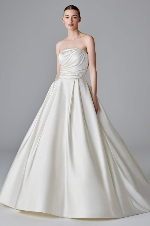Sculpted satin ruching meets a full pleated skirt in this effortlessly regal ball gown
