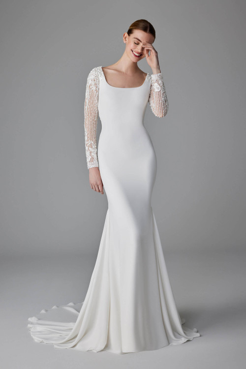 Sleek crepe meets sheer beaded sleeves in this chic, sculpted silhouette Sleek crepe meets sheer beaded sleeves in this chic, sculpted silhouette