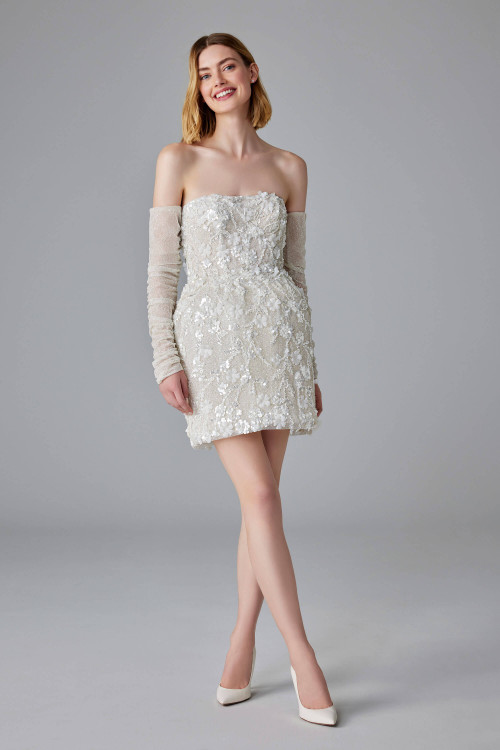 This dazzling mini dress stuns with 3D floral appliqués and sheer off-shoulder sleeves This dazzling mini dress stuns with 3D floral appliqués and sheer off-shoulder sleeves