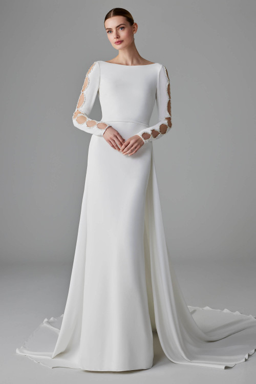 Sheath gown with a bateau neckline, open circle sleeves, and sleek detachable crepe train Sheath gown with a bateau neckline, open circle sleeves, and sleek detachable crepe train