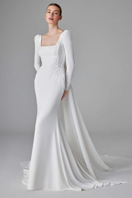 This sleek fitted crepe gown with a square neckline, embroidered bodice, and detachable overskirt This sleek fitted crepe gown with a square neckline, embroidered bodice, and detachable overskirt