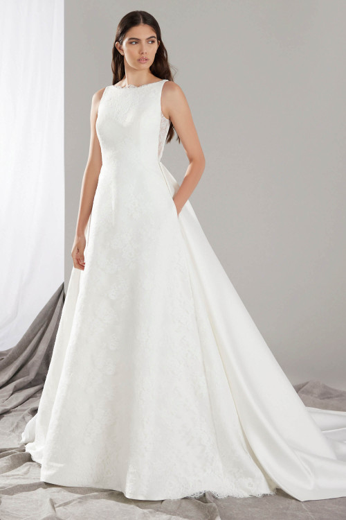 Timeless A-line gown with a bateau neckline, and an elegant skirt with pockets Timeless A-line gown with a bateau neckline, and an elegant skirt with pockets