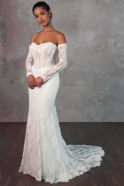 This lace gown stuns with exposed boning, detachable sheer lace sleeves, and a sculpted silhouette This lace gown stuns with exposed boning, detachable sheer lace sleeves, and a sculpted silhouette