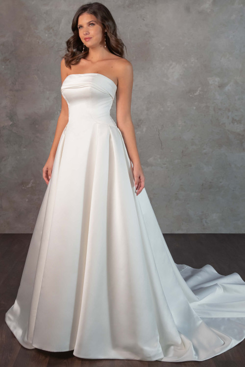 Understated and striking, this strapless satin gown features a folded neckline and full pleated skirt Understated and striking, this strapless satin gown features a folded neckline and full pleated skirt