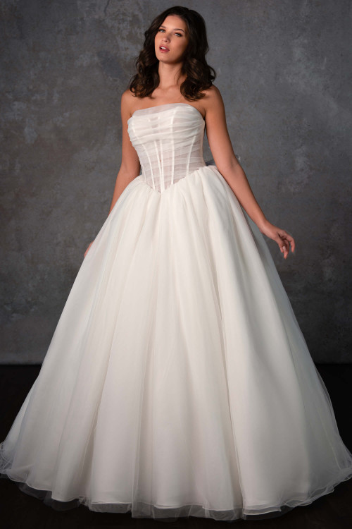 A romantic ball gown with a pleated sheer corset bodice and dreamy layers of soft tulle A romantic ball gown with a pleated sheer corset bodice and dreamy layers of soft tulle