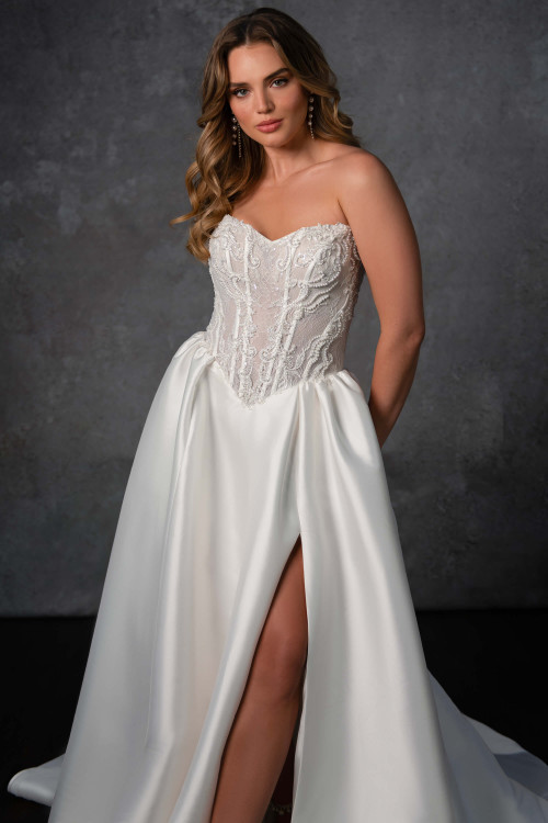 This strapless gown stuns with a sheer corset lace bodice, mikado skirt, and daring thigh-high slit This strapless gown stuns with a sheer corset lace bodice, mikado skirt, and daring thigh-high slit