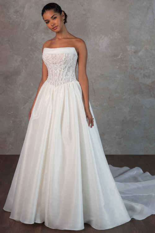 This strapless ballgown features a sheer corset bodice with floral embroidery and a full organza skirt This strapless ballgown features a sheer corset bodice with floral embroidery and a full organza skirt