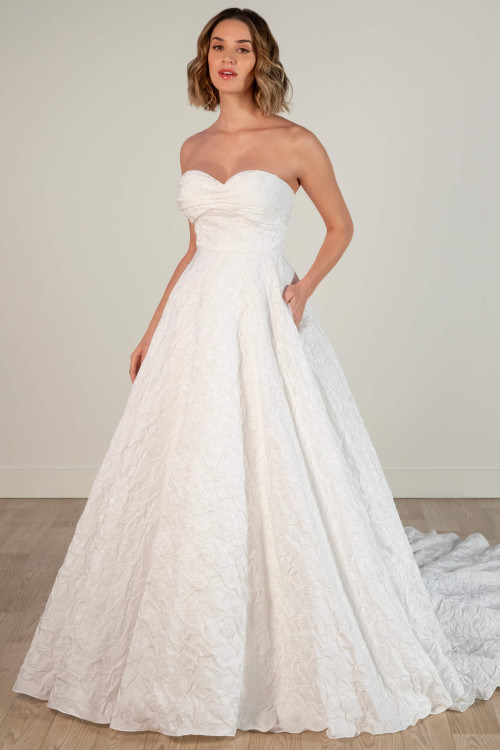 Strapless A-line wedding dress with sweetheart neckline and floral jacquard texture, front view. Strapless A-line wedding dress with sweetheart neckline and floral jacquard texture, front view.