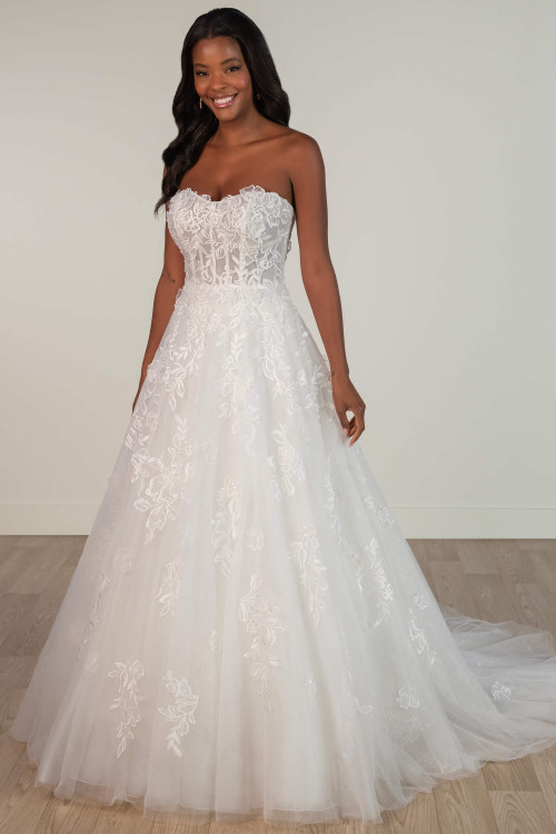 Strapless A-line wedding dress with floral lace and sheer boned bodice, front view. Strapless A-line wedding dress with floral lace and sheer boned bodice, front view.
