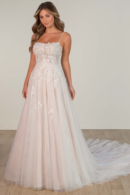 Front view of A-line wedding gown with floral lace appliqués and beaded straps. Front view of A-line wedding gown with floral lace appliqués and beaded straps.