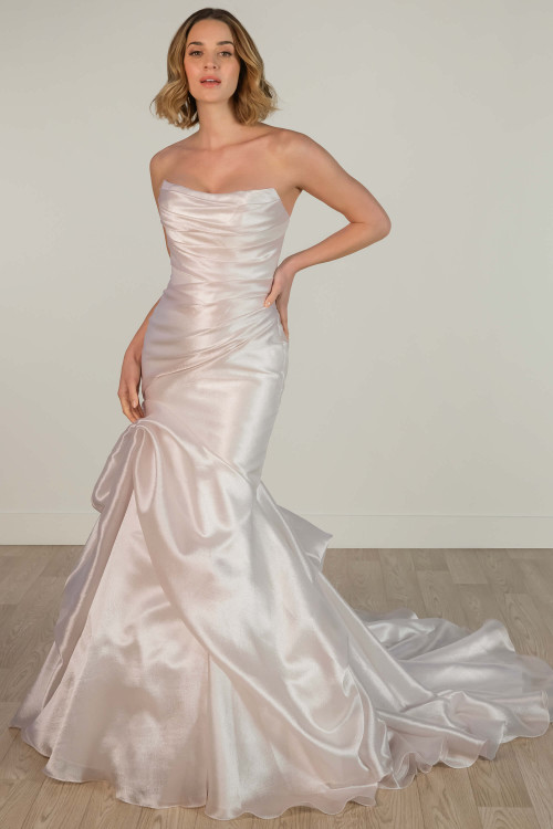 Ruched satin bodice and tiered mermaid skirt create a sculpted, luxurious bridal silhouette. Ruched satin bodice and tiered mermaid skirt create a sculpted, luxurious bridal silhouette.