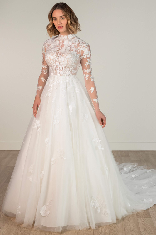 Elegant A-line wedding gown features illusion lace sleeves and a full soft tulle skirt. Elegant A-line wedding gown features illusion lace sleeves and a full soft tulle skirt.