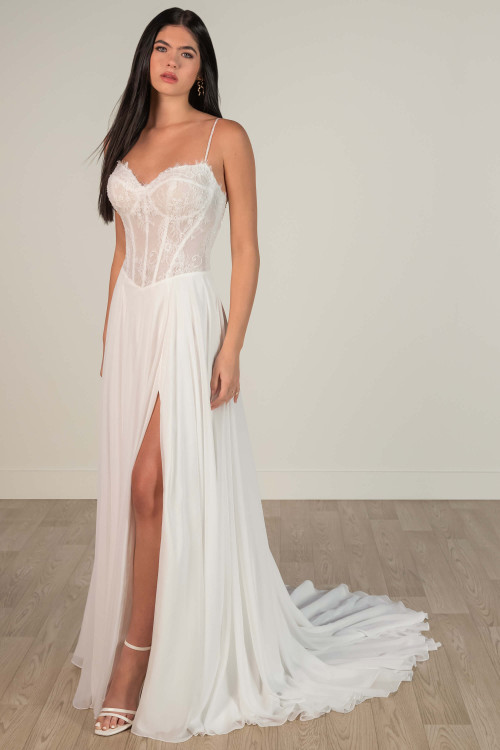 Chiffon wedding gown with sheer lace corset bodice and high slit for modern romance. Chiffon wedding gown with sheer lace corset bodice and high slit for modern romance.