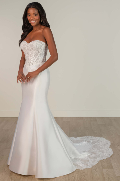 A sheer corset bodice with lace appliqués tops this sleek satin gown with a romantic lace train A sheer corset bodice with lace appliqués tops this sleek satin gown with a romantic lace train