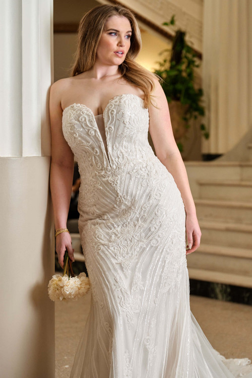 Plus-size bride wearing the Maggie Wedding Dress Rome A-line gown, highlighting the strapless sweetheart neckline and sequin lace. Plus-size bride wearing the Maggie Wedding Dress Rome A-line gown, highlighting the strapless sweetheart neckline and sequin lace.
