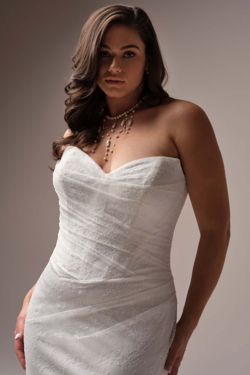 Close-up of the Sasha gown's bodice, highlighting the flattering ruched lace and strapless sweetheart neckline.