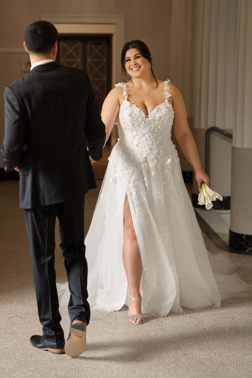 Plus-size bride models the Sottero & Midgley Wicklow A-line gown, highlighting the romantic 3D florals and side slit. Plus-size bride models the Sottero & Midgley Wicklow A-line gown, highlighting the romantic 3D florals and side slit.