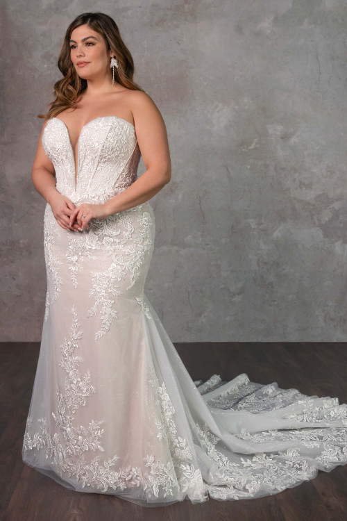 A plus size bride wearing the Essense of Australia D4341, a fit-and-flare gown with a detailed beaded corset bodice. A plus size bride wearing the Essense of Australia D4341, a fit-and-flare gown with a detailed beaded corset bodice.