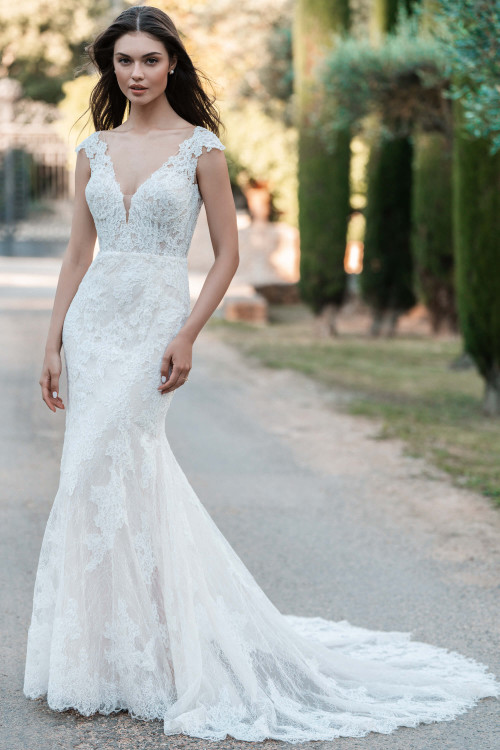 Allure Bridals A1302 front—Chantilly lace sheath with deep V-neck and cap sleeves on model. Allure Bridals A1302 front—Chantilly lace sheath with deep V-neck and cap sleeves on model.