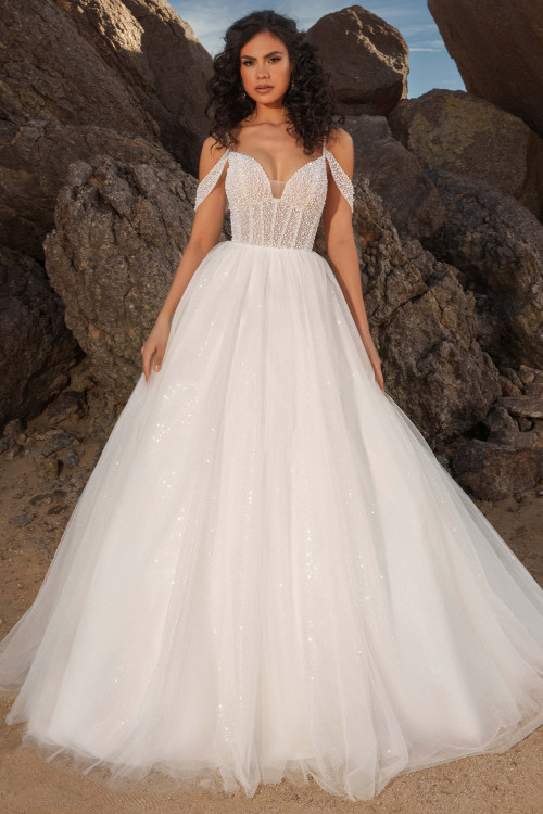 Front view of Kitty Chen Sahara ballgown with plunging sweetheart neckline and sparkle skirt Front view of Kitty Chen Sahara ballgown with plunging sweetheart neckline and sparkle skirt