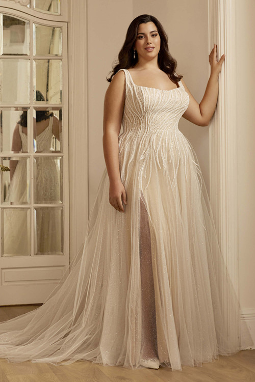 Front view of the Portrait by Enzoani Caroline plus-size gown with scoop neckline and beaded lace bodice. Front view of the Portrait by Enzoani Caroline plus-size gown with scoop neckline and beaded lace bodice.