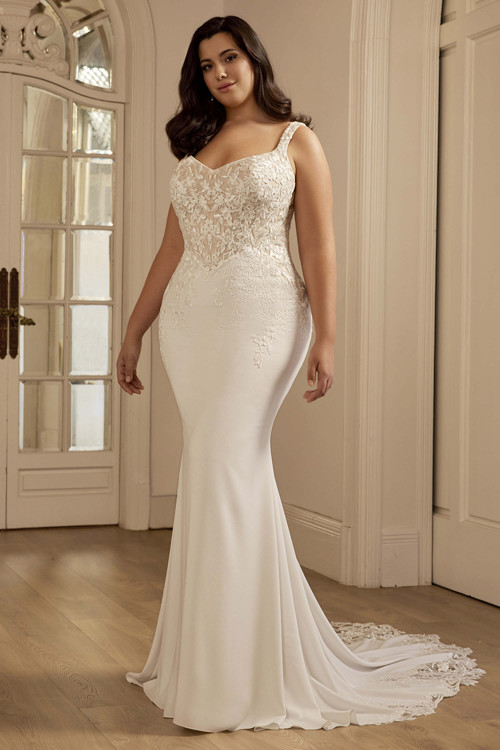 Front view of the Portrait by Enzoani Spencer plus-size fitted gown with curved neckline and lace bodice. Front view of the Portrait by Enzoani Spencer plus-size fitted gown with curved neckline and lace bodice.
