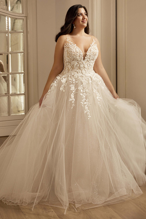 Front view of the Portrait by Enzoani Olani plus-size gown with plunging V-neckline and floral lace bodice. Front view of the Portrait by Enzoani Olani plus-size gown with plunging V-neckline and floral lace bodice.