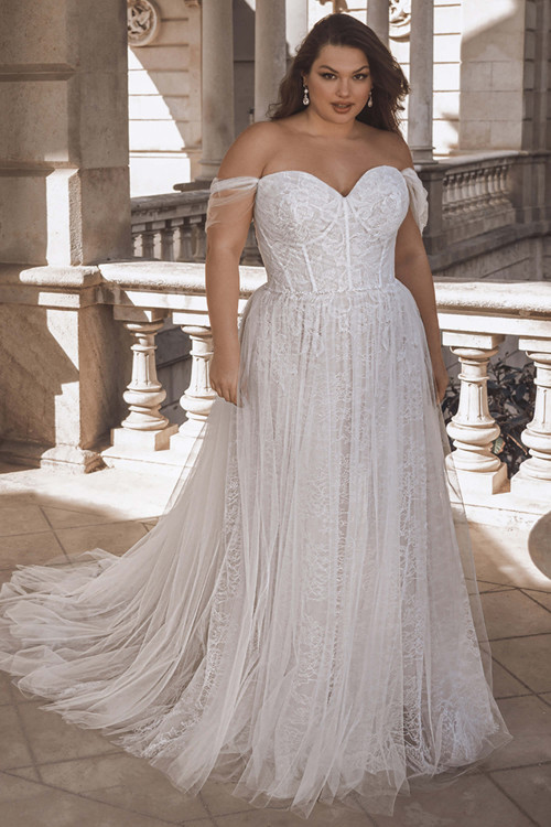 Front view of the Portrait by Enzoani Fable plus-size A-line gown with sweetheart neckline and off-the-shoulder tulle straps. Front view of the Portrait by Enzoani Fable plus-size A-line gown with sweetheart neckline and off-the-shoulder tulle straps.