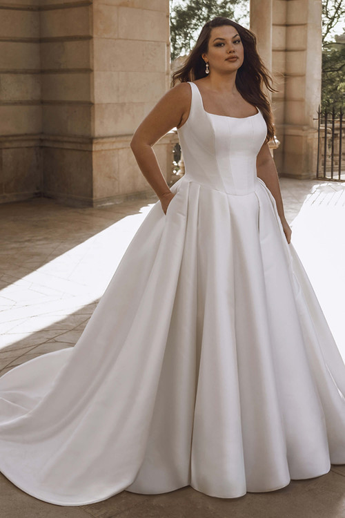 Front view of the Portrait by Enzoani Torvi plus-size ballgown with square neckline and full skirt. Front view of the Portrait by Enzoani Torvi plus-size ballgown with square neckline and full skirt.