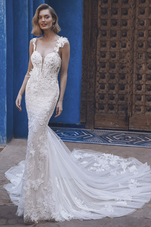 Bride wearing Ulyssa mermaid gown with plunging sweetheart bodice and embellished straps. Bride wearing Ulyssa mermaid gown with plunging sweetheart bodice and embellished straps.