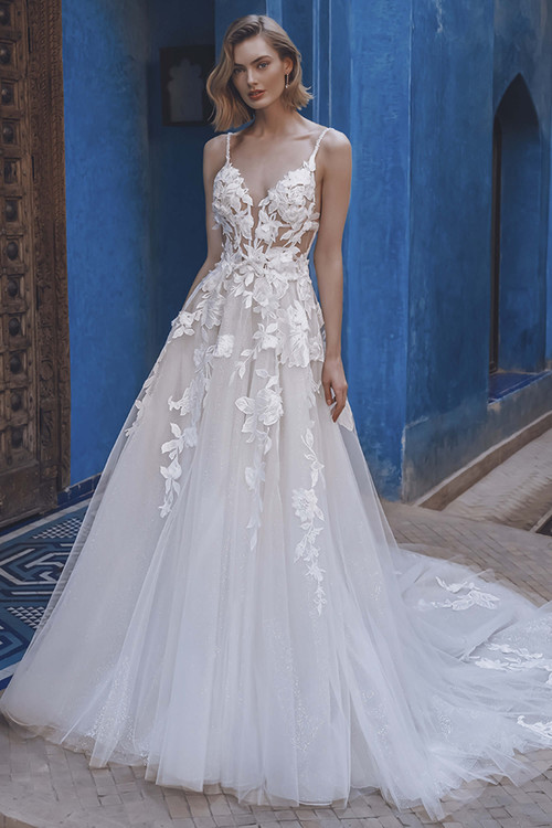 Bride in Enzoani Unisse A-line gown with plunging neckline and illusion corset bodice. Bride in Enzoani Unisse A-line gown with plunging neckline and illusion corset bodice.