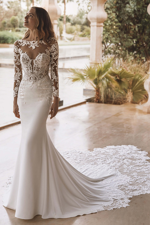 Front view of Enzoani Vienna wedding gown with illusion neckline and lace-appliquéd bodice. Front view of Enzoani Vienna wedding gown with illusion neckline and lace-appliquéd bodice.
