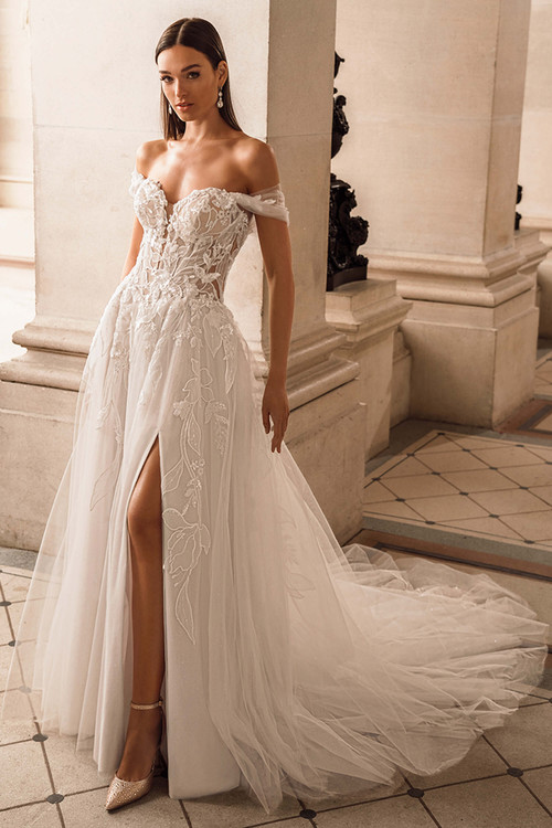 Front view of ÉLYSÉE Fae A-line wedding gown with off-the-shoulder straps and slit skirt Front view of ÉLYSÉE Fae A-line wedding gown with off-the-shoulder straps and slit skirt