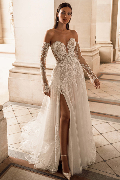 Front view of the ÉLYSÉE Faith wedding gown showcasing A-line silhouette with slit and lace bodice. Front view of the ÉLYSÉE Faith wedding gown showcasing A-line silhouette with slit and lace bodice.