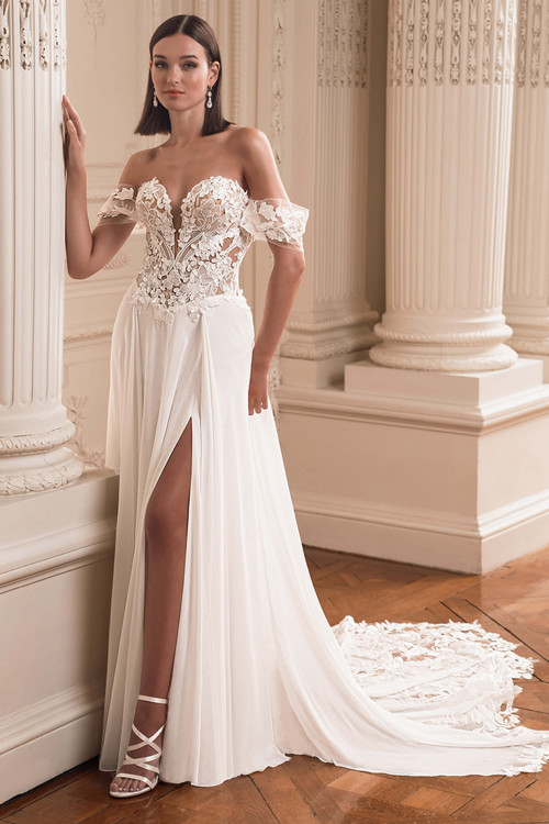 Front view of the ÉLYSÉE Firouze A-line gown with sweetheart neckline, chiffon skirt, and thigh-high slit. Front view of the ÉLYSÉE Firouze A-line gown with sweetheart neckline, chiffon skirt, and thigh-high slit.