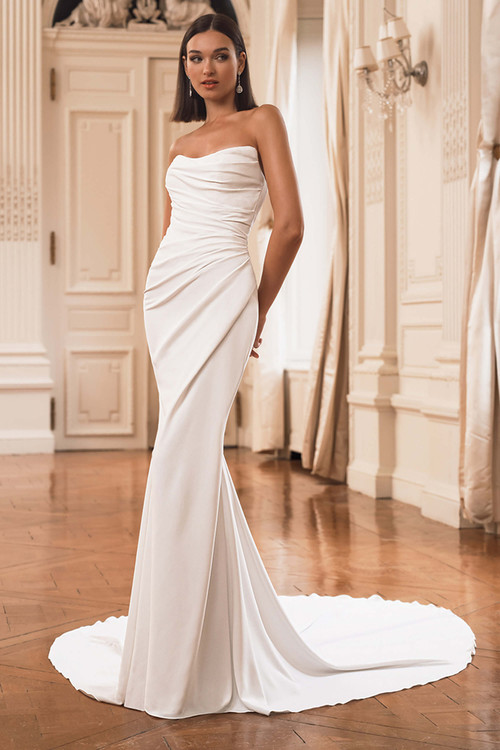 Front view of the ÉLYSÉE Florianne sheath gown with strapless scoop neckline and ruched draped bodice. Front view of the ÉLYSÉE Florianne sheath gown with strapless scoop neckline and ruched draped bodice.